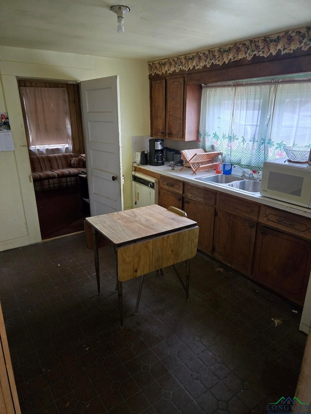 kitchen featuring sink and white appliances