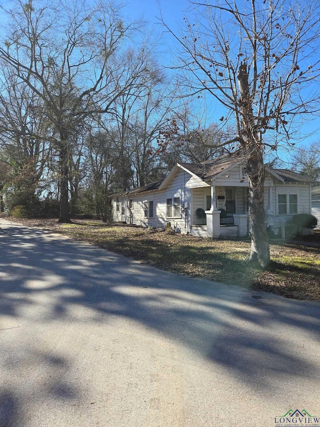 view of property exterior with covered porch