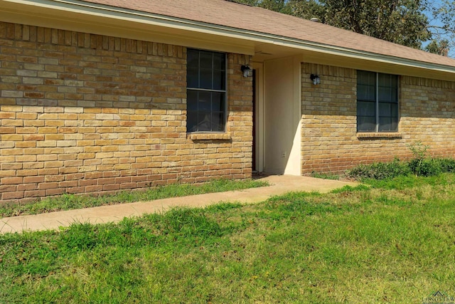 property entrance with a yard