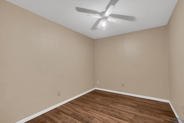 spare room featuring a textured ceiling, ceiling fan, and dark wood-type flooring