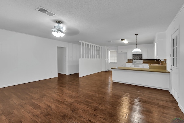 kitchen featuring white cabinetry, sink, white electric range oven, kitchen peninsula, and decorative backsplash