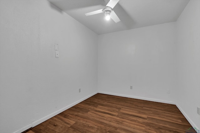 spare room with dark hardwood / wood-style flooring and ceiling fan