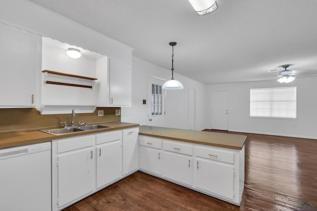 kitchen with kitchen peninsula, white cabinets, sink, pendant lighting, and dishwasher