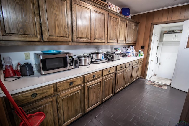 kitchen featuring wooden walls and ornamental molding