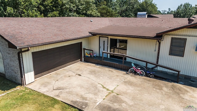 single story home featuring a porch and a garage