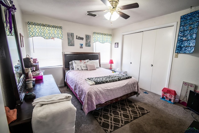 bedroom with carpet flooring, ceiling fan, multiple windows, and a closet