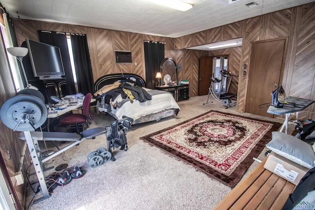 carpeted bedroom with wooden walls