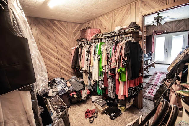 spacious closet featuring french doors, carpet floors, and ceiling fan