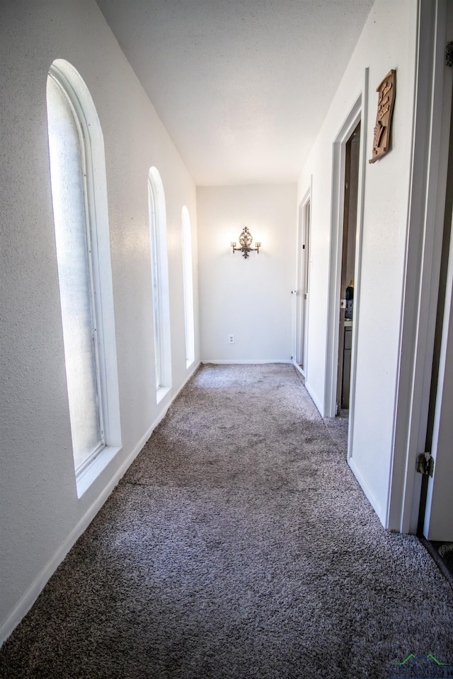 hallway with light colored carpet