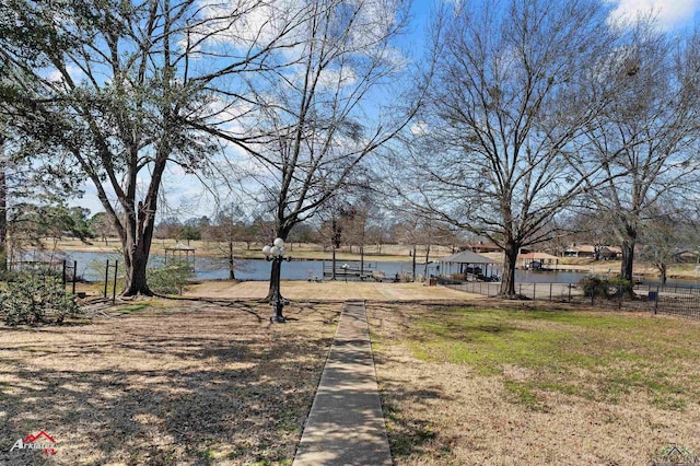 view of yard with a water view and fence