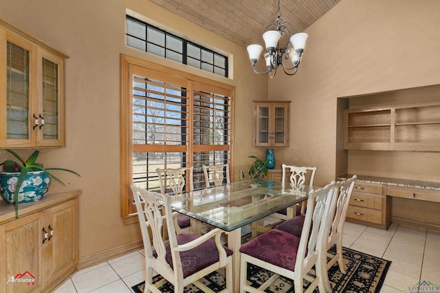 dining space featuring high vaulted ceiling, built in desk, light tile patterned floors, wood ceiling, and a chandelier