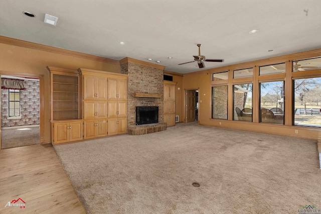 unfurnished living room featuring recessed lighting, ornamental molding, a brick fireplace, light carpet, and ceiling fan