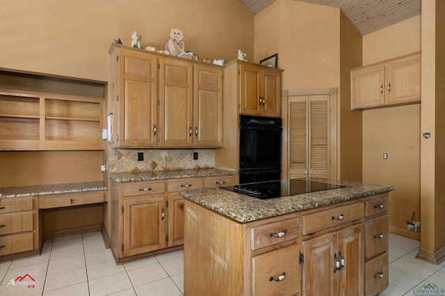 kitchen featuring built in study area, lofted ceiling, light stone countertops, black appliances, and light tile patterned flooring