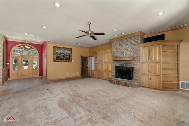 unfurnished living room featuring visible vents, light colored carpet, crown molding, a fireplace, and recessed lighting