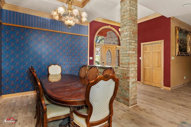 dining space featuring an inviting chandelier, baseboards, crown molding, and wood finished floors