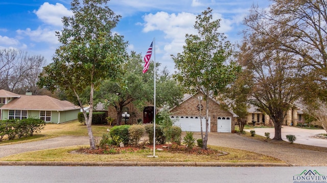 ranch-style home with a garage and driveway