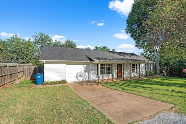 ranch-style home with a garage, a front lawn, and covered porch