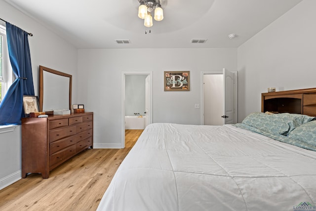 bedroom with light wood-style floors, baseboards, visible vents, and ceiling fan