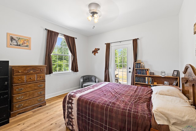 bedroom with light wood-type flooring, access to outside, and baseboards