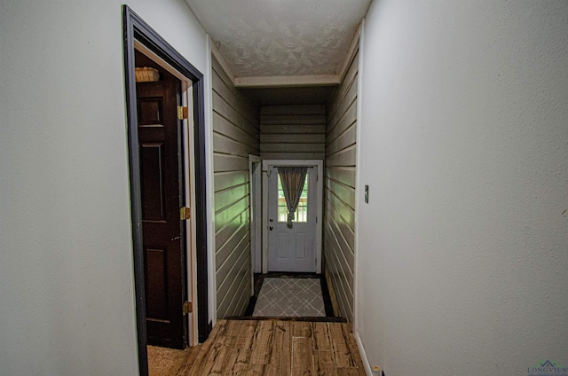 entryway with hardwood / wood-style floors and a textured ceiling