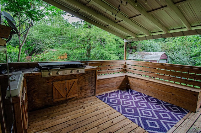 wooden terrace with a grill and exterior kitchen