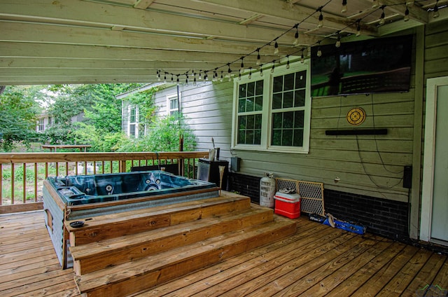 wooden terrace featuring an outdoor hot tub