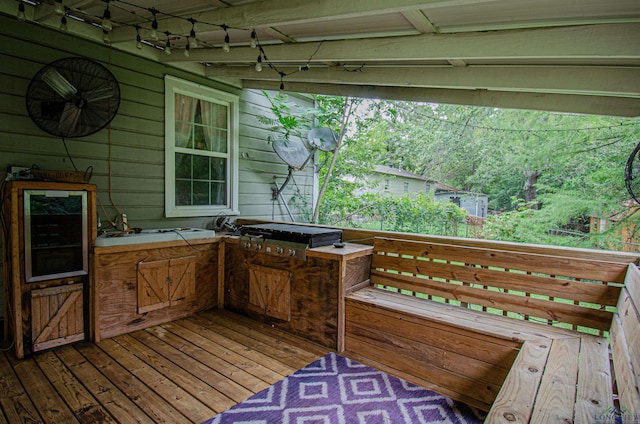 wooden terrace with area for grilling and exterior kitchen