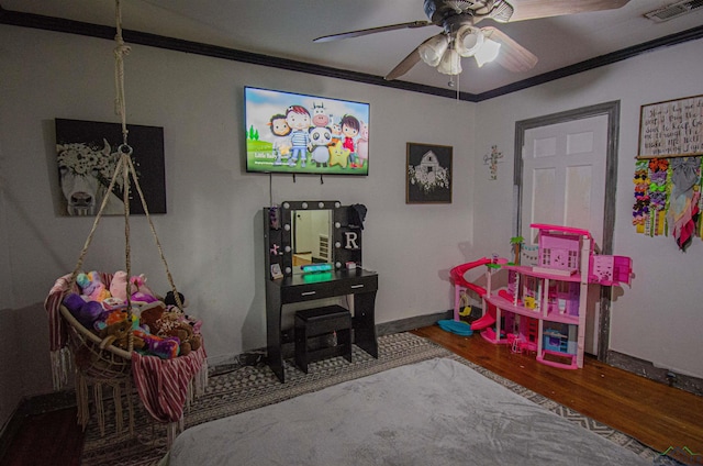 game room featuring ceiling fan, wood-type flooring, and crown molding