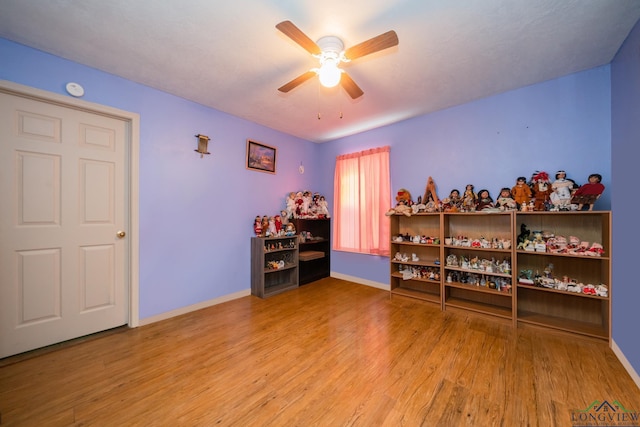 miscellaneous room with ceiling fan and light hardwood / wood-style flooring