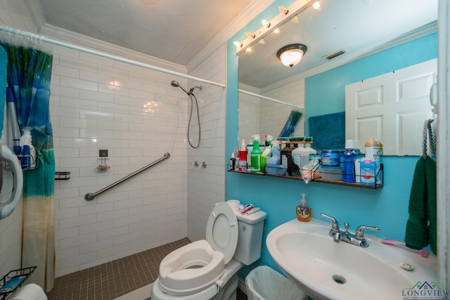 bathroom with a shower with shower curtain, toilet, crown molding, and sink