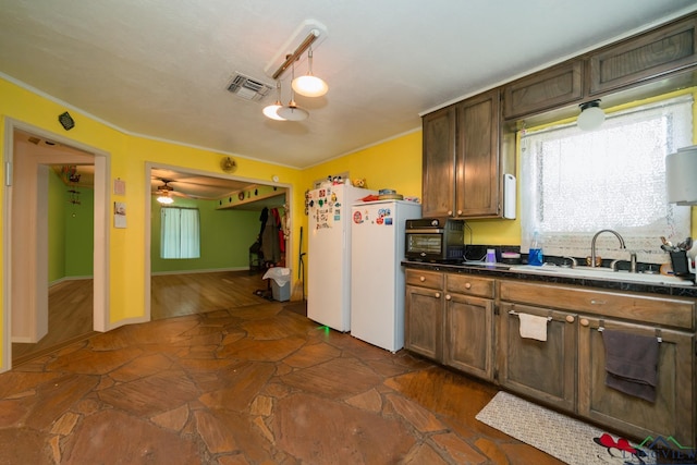 kitchen with white refrigerator, crown molding, sink, ceiling fan, and decorative light fixtures