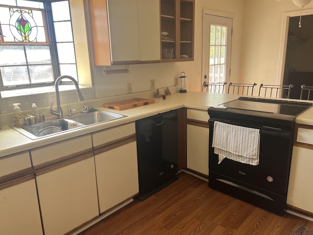 kitchen featuring sink, white cabinets, black appliances, and dark hardwood / wood-style floors