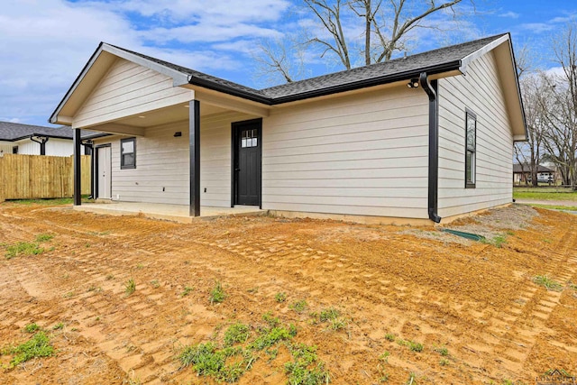 ranch-style home featuring fence