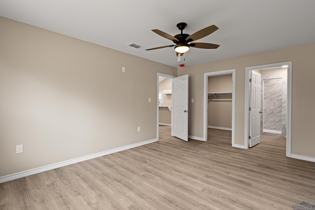 unfurnished bedroom with light wood-type flooring, visible vents, and baseboards