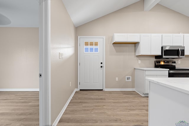 kitchen with baseboards, lofted ceiling with beams, stainless steel appliances, white cabinets, and light wood-type flooring