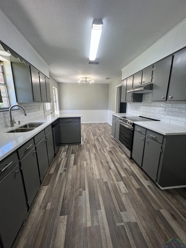 kitchen featuring backsplash, sink, stainless steel appliances, and a textured ceiling