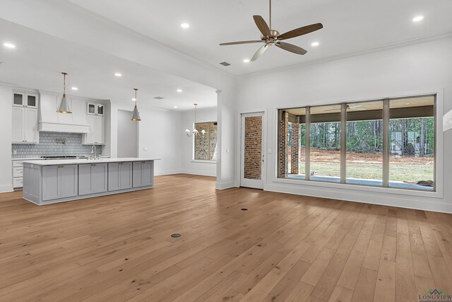 130 Elk Dr, Longview, TX 75605 - unfurnished living room featuring light wood-style flooring, a ceiling fan, and plenty of natural light