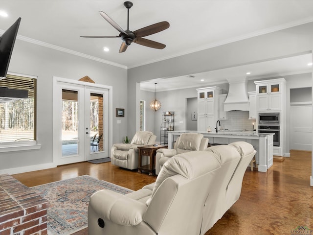 living room featuring sink, french doors, ceiling fan, and ornamental molding