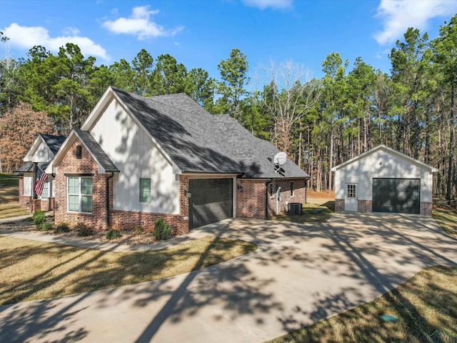 view of front of house with a front lawn and central AC