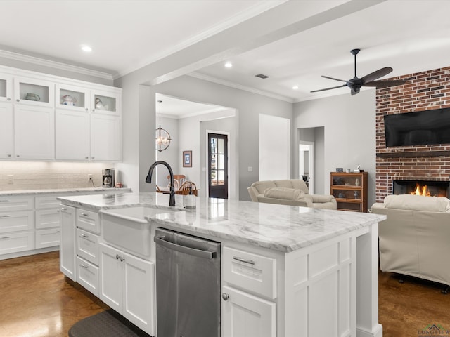 kitchen featuring white cabinetry, dishwasher, a kitchen island with sink, and a fireplace