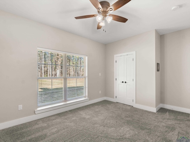 carpeted empty room with ceiling fan