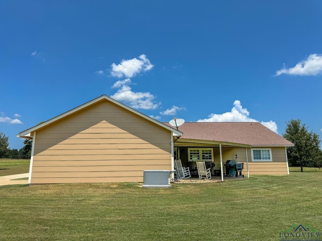 back of house with a lawn