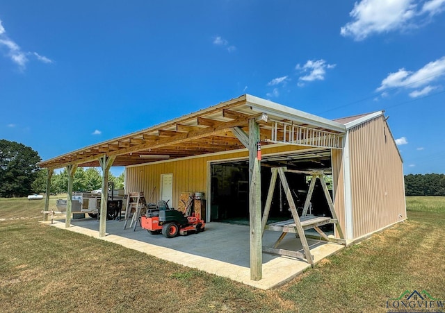 back of property featuring a yard and an outdoor structure