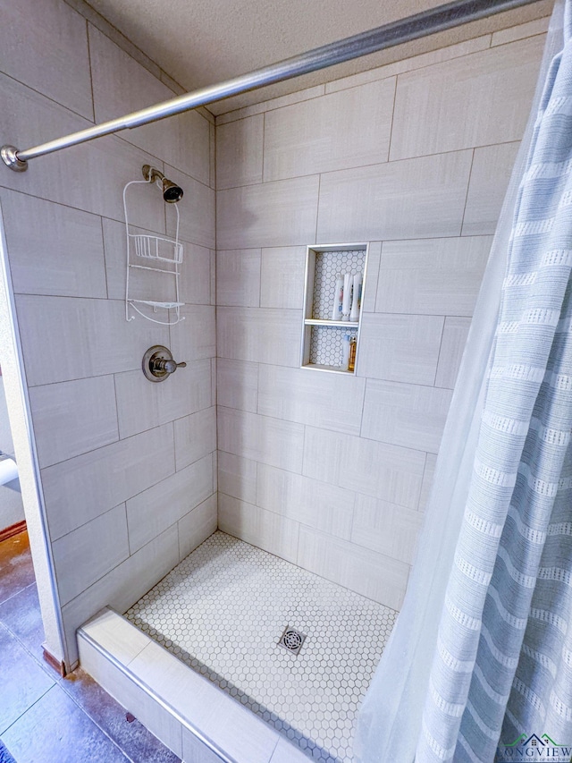 bathroom with tile patterned floors and walk in shower