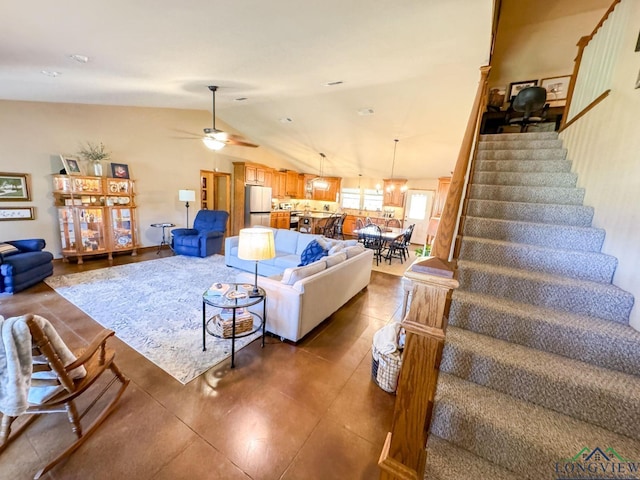 living room featuring ceiling fan and lofted ceiling