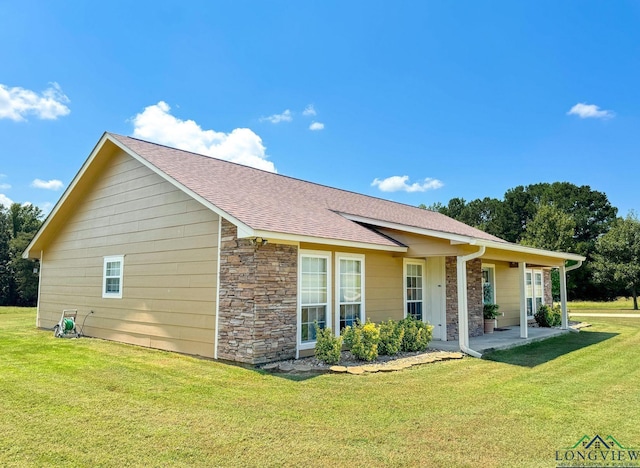 rear view of house with a lawn