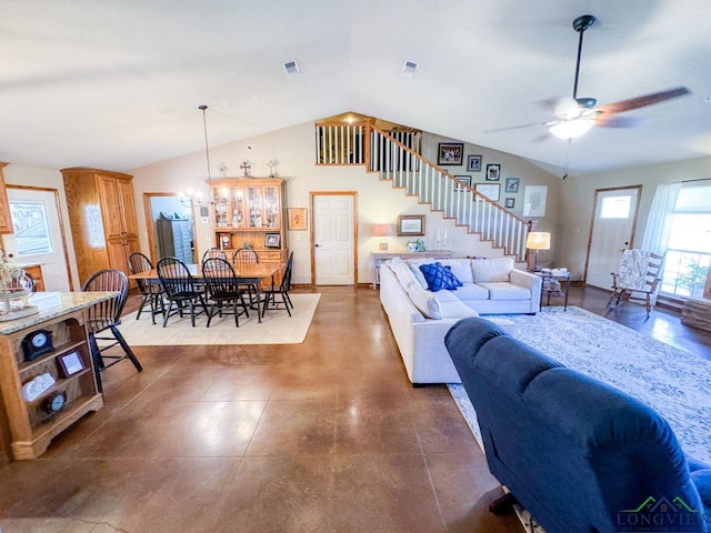 living room with ceiling fan with notable chandelier and vaulted ceiling