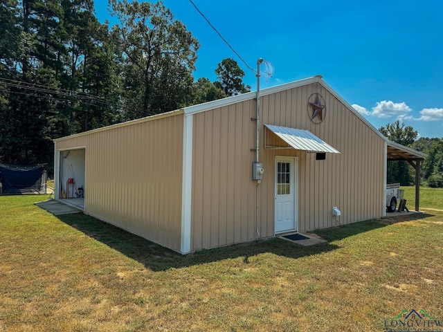 view of outbuilding with a yard