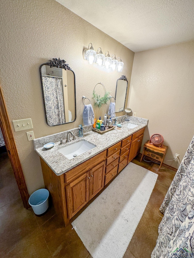 bathroom featuring a textured ceiling, vanity, and tile patterned floors