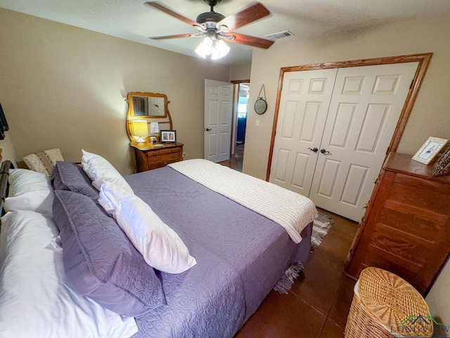 tiled bedroom featuring a closet and ceiling fan